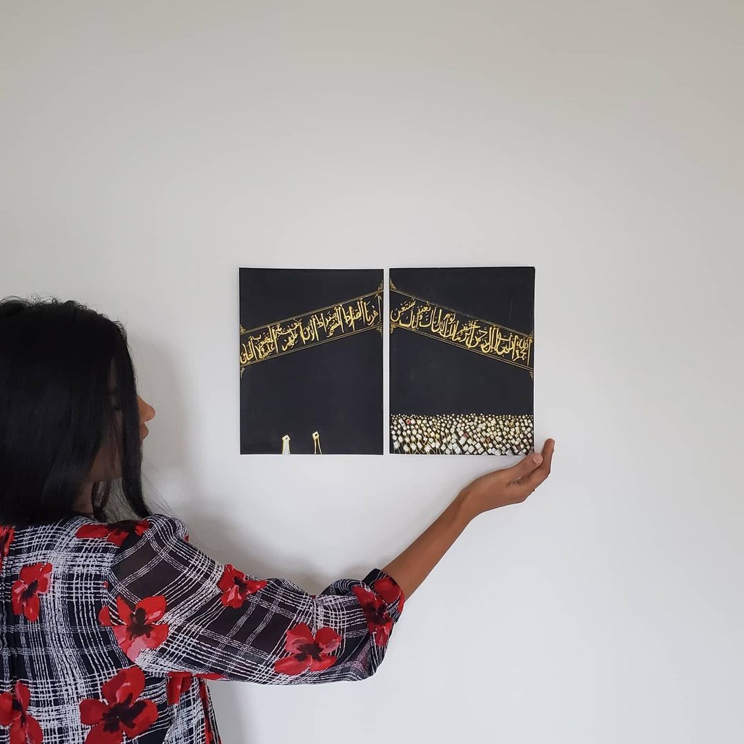 Modern Wall Art and Islamic Decor - Nadia Zeeshan holding two Kaabah Paintings hanged on a wall - Famous Islamic Artist